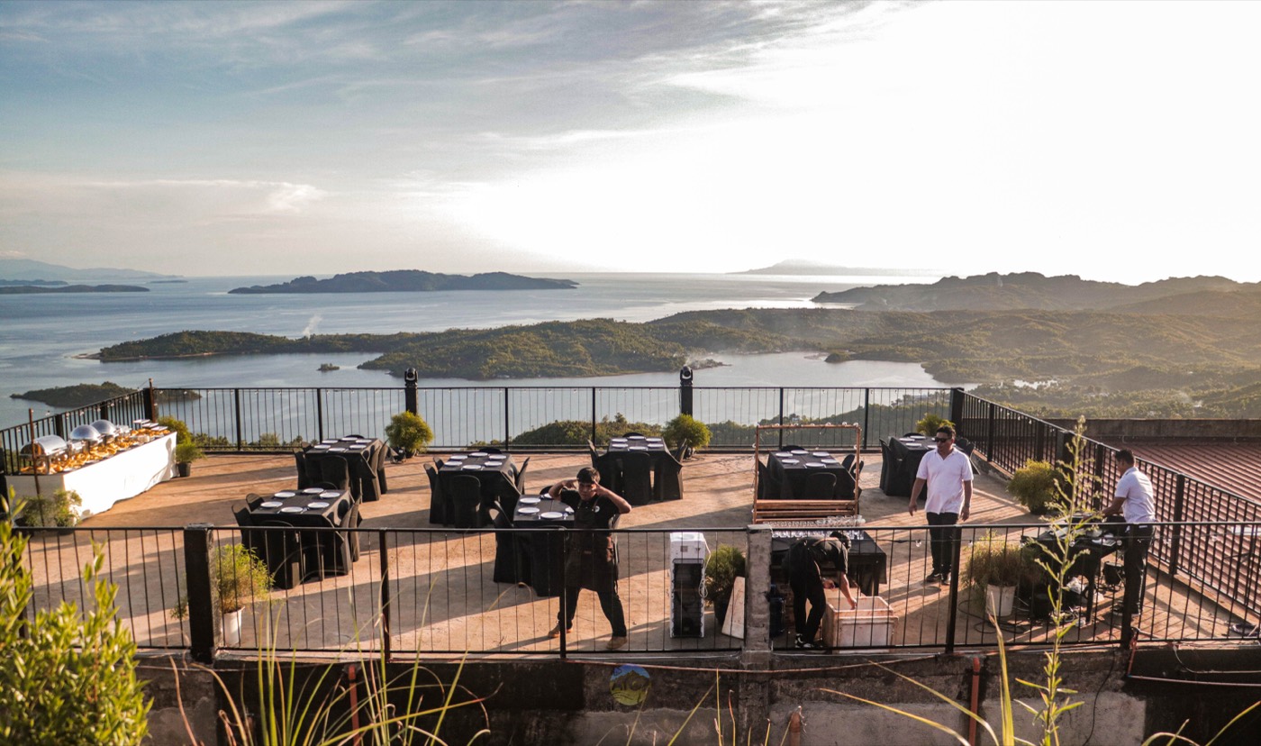 The open-air terrace at Laaganan, tables set along the railing above the Dinagat Islands