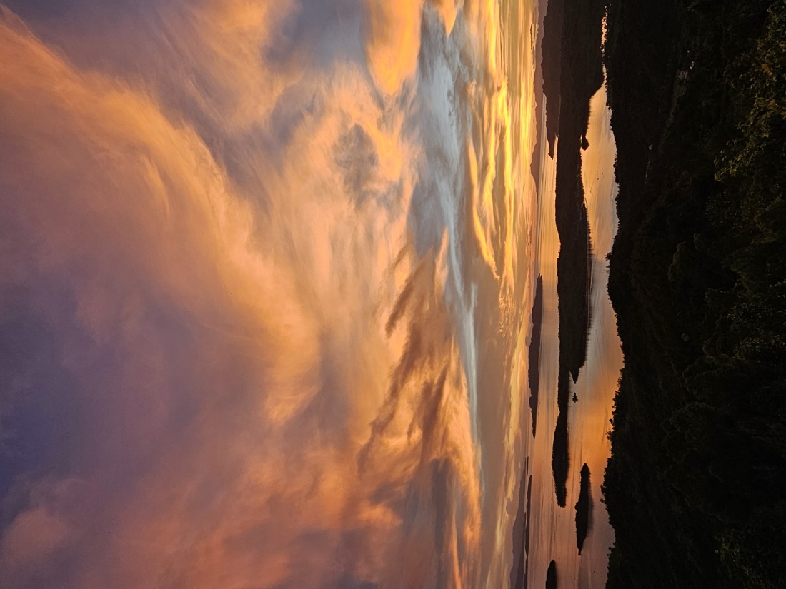 Golden sunset clouds over the sea and islands
